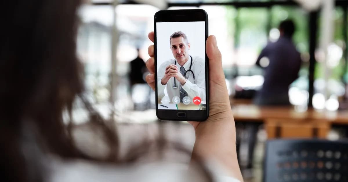 A patient speaking to a doctor by video call on a smartphone
