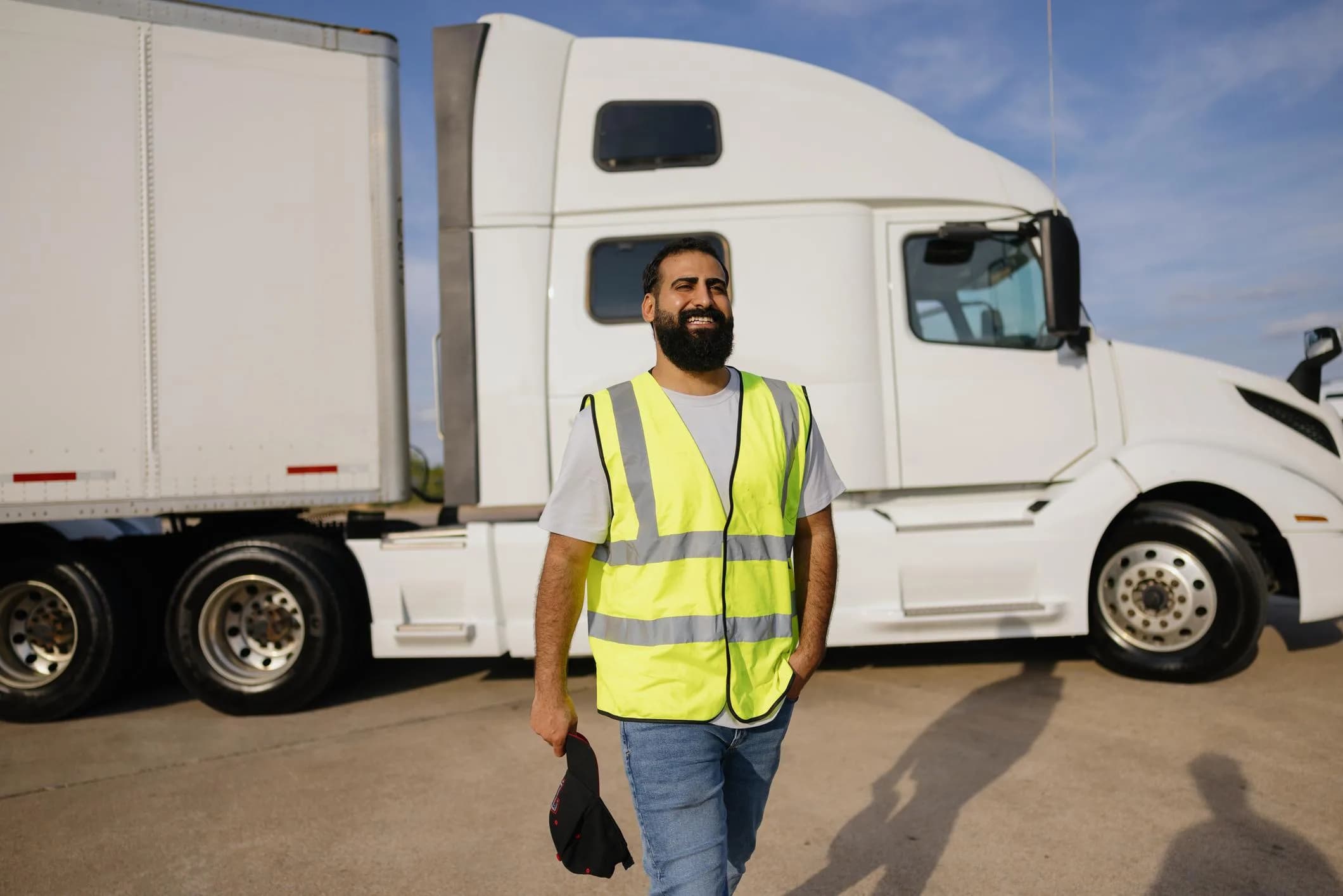 Truck driver standing in front of a truck